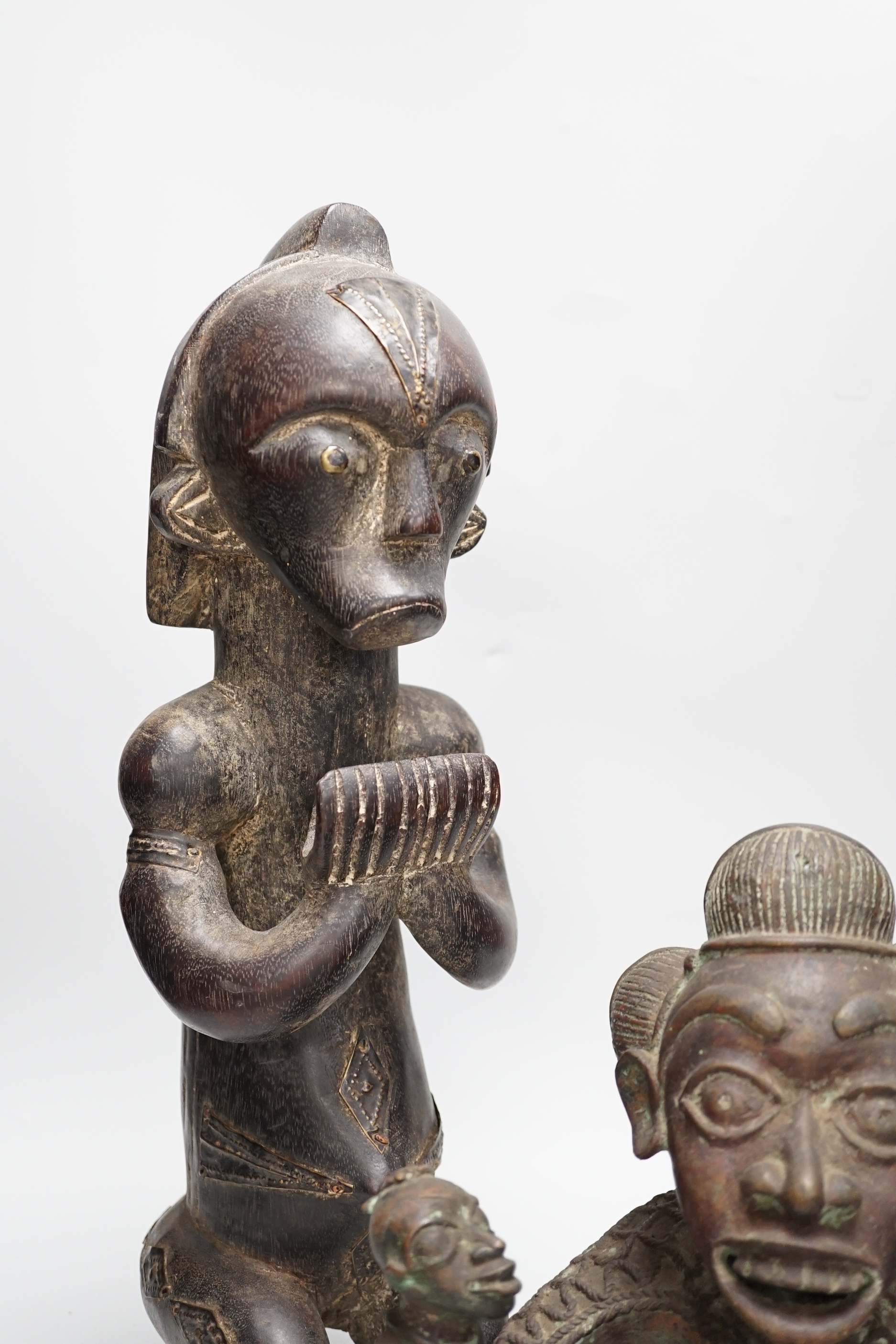 A Yoruba bronze group and a hardwood figure, tallest 47cm